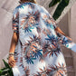 Stylish woman in a Birds of Paradise printed open front cover up, perfect for beach days and pool lounging.