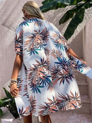 Stylish woman in a Birds of Paradise printed open front cover up, perfect for beach days and pool lounging.