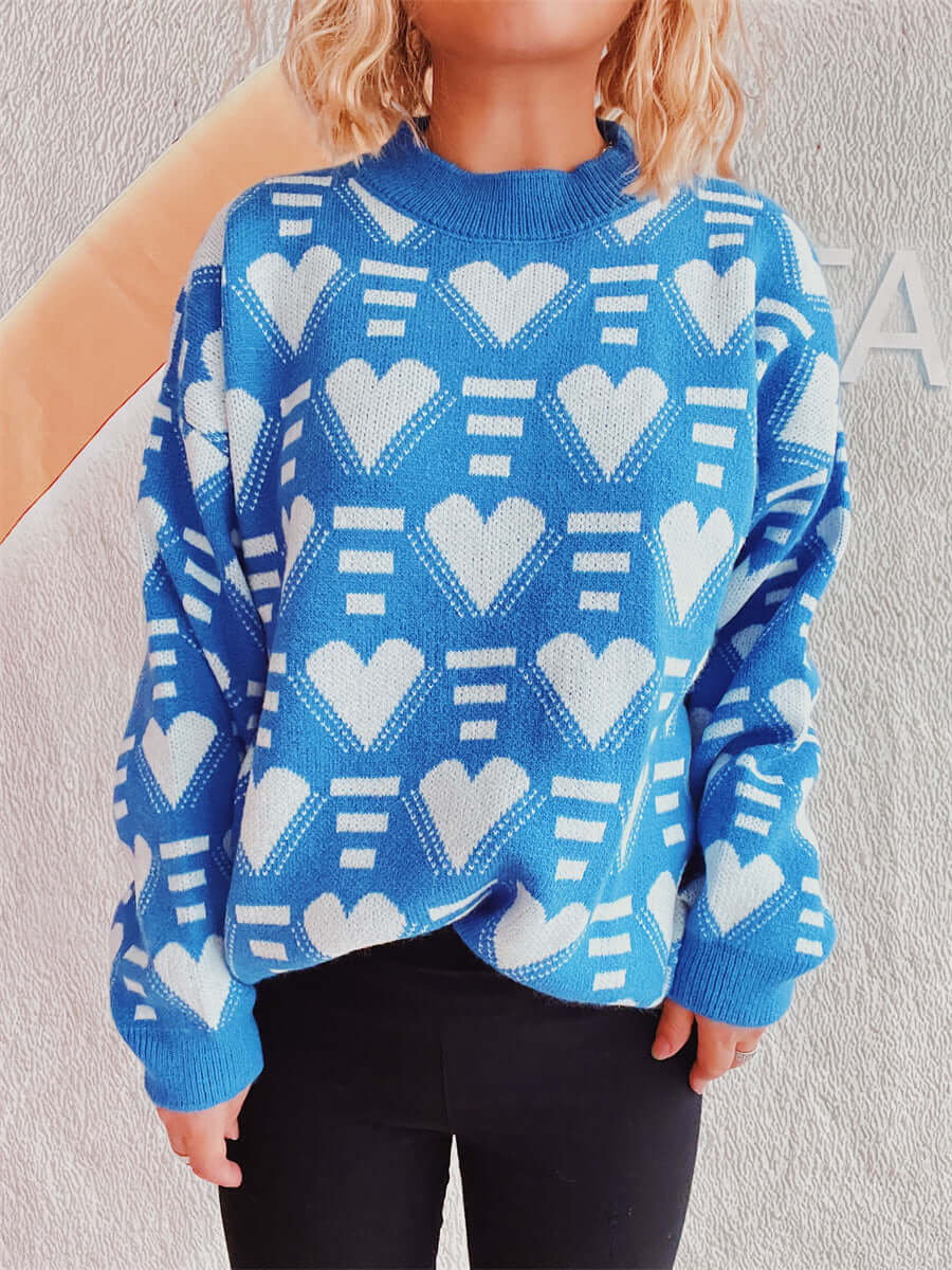 Woman wearing Bella Road Heart Contrast Long Sleeve Dropped Shoulder Sweater in blue with white heart patterns