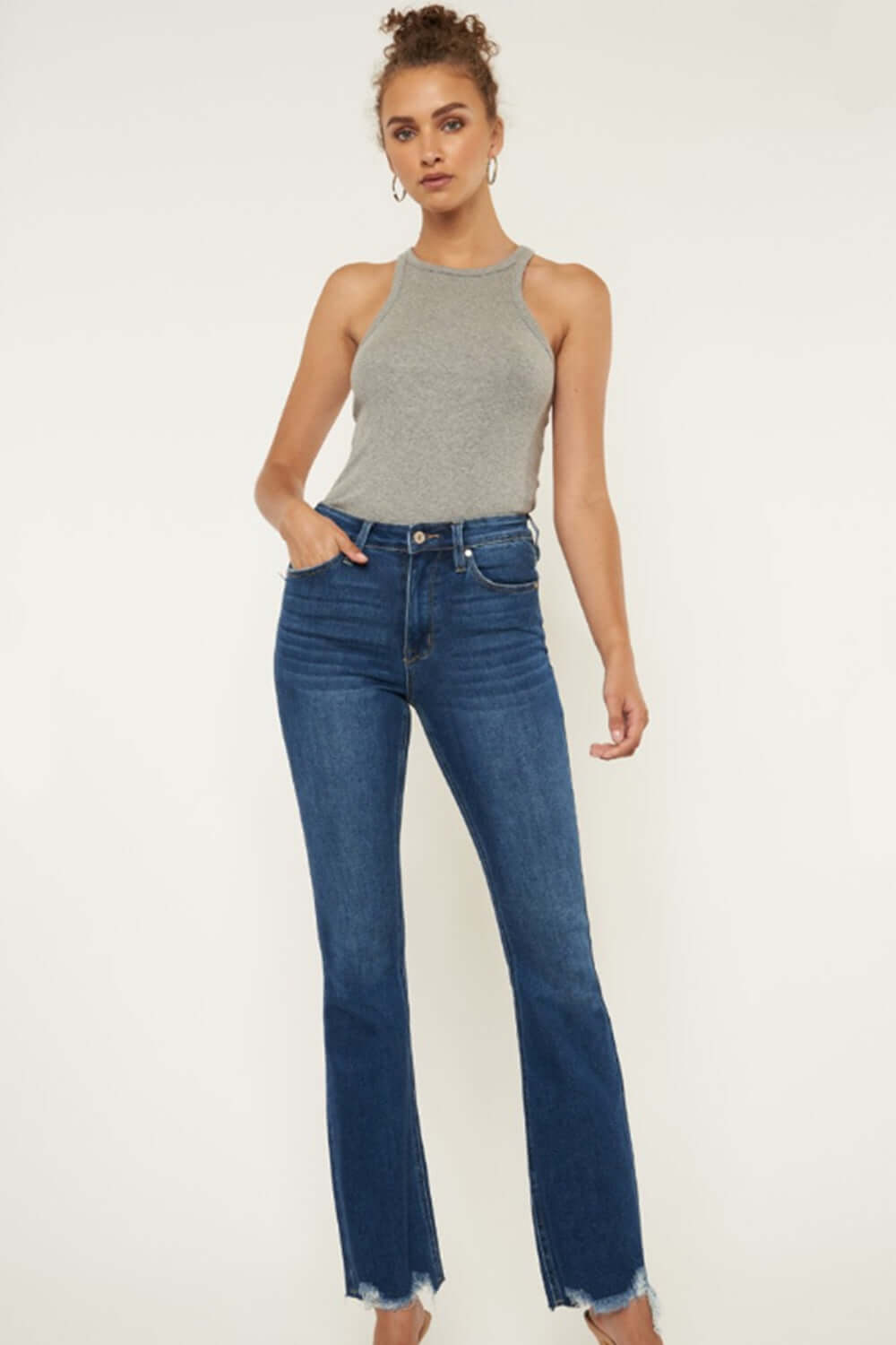 Fashion-forward individual wearing Cat's Whiskers Raw Hem Flare Jeans with raw hem and retro vibe, perfect for versatile stylish outfits.