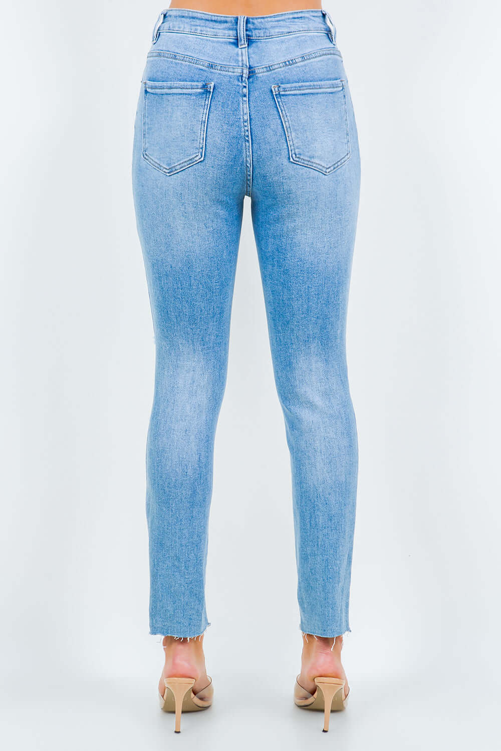 High waist destroyed jeans with distressed details and comfortable fit, perfect for a trendy and flattering look.