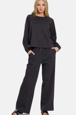 Zenana Round Neck Raglan Sleeve Top and Elastic Waist Pants Set in stylish black, perfect for casual outings and relaxation.