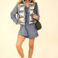 Woman wearing VERY J Shiny Metallic Zip Up Puffer Vest with high neck and side pockets, styled over a blue dress and white sneakers