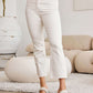 Mini Mia tummy control high waist raw hem jeans showcasing style and comfort with moderate stretch and pocketed design.