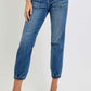 Stylish high-rise ankle jogger jeans with elastic cuffs and a sleek silhouette, paired with white heels for a chic look.