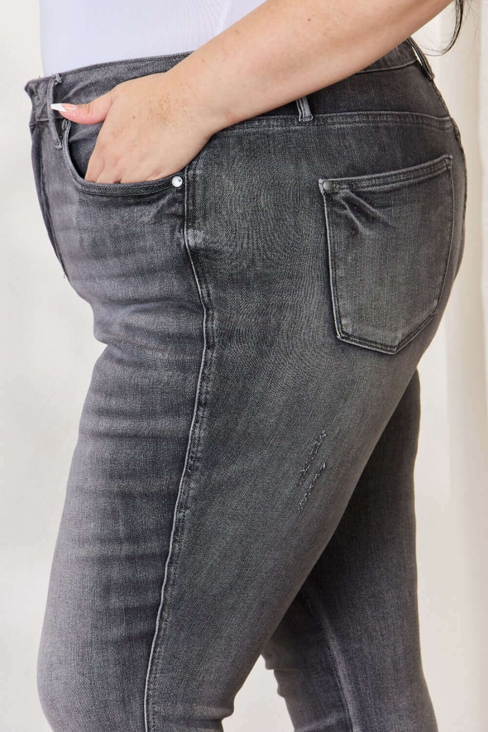 High Waist Tummy Control Release Hem Skinny Jeans by Judy Blue in dark wash, showcasing side pocket and hip detail.