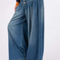 Stylish SAGE+FIG wide leg jeans with smocked waistband, washed denim, and pockets, perfect for a chic and comfortable look.