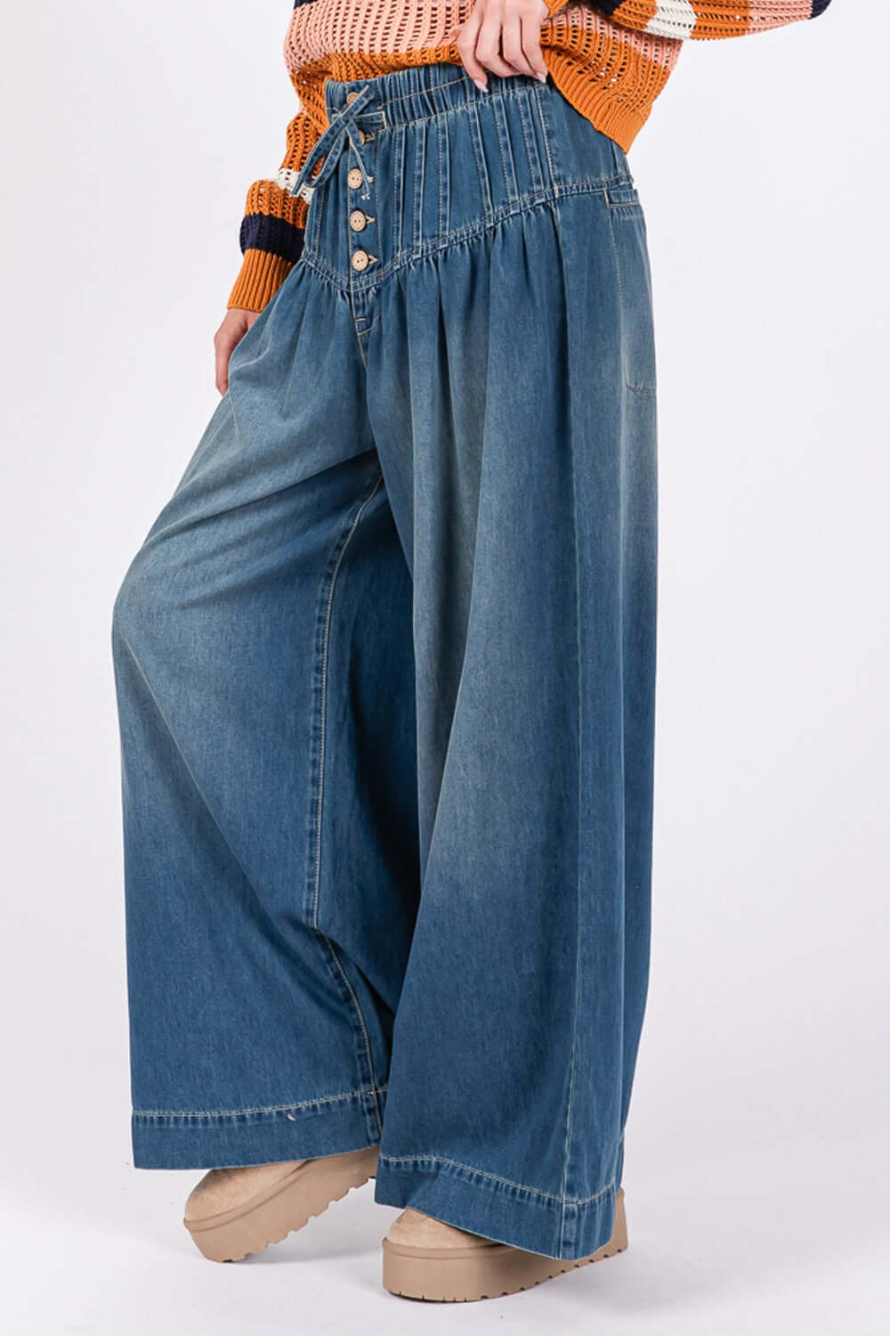 Stylish SAGE+FIG wide leg jeans with smocked waistband, washed denim, and pockets, perfect for a chic and comfortable look.