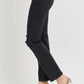 Black high-rise wide waistband ankle bootcut jeans paired with clear heels, showcasing a trendy and modern style.