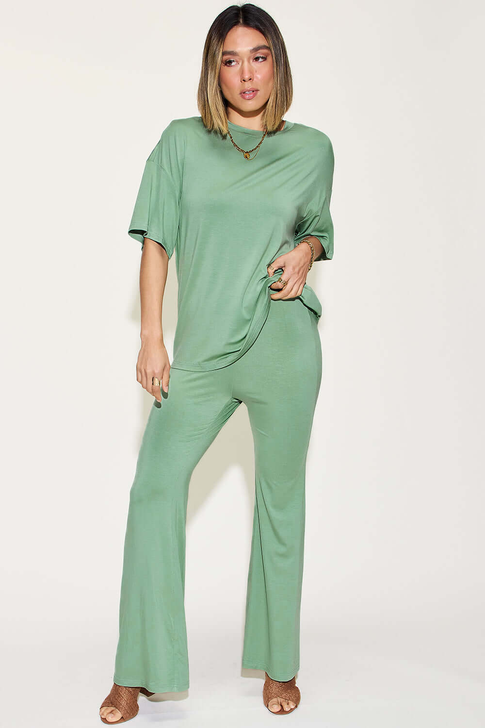 Woman wearing a green two-piece Bamboo Drop Shoulder T-Shirt and Flare Pants Set.