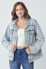 Model wearing RISEN distressed drawstring hooded denim jacket with casual outfit, showcasing rugged style and comfort.