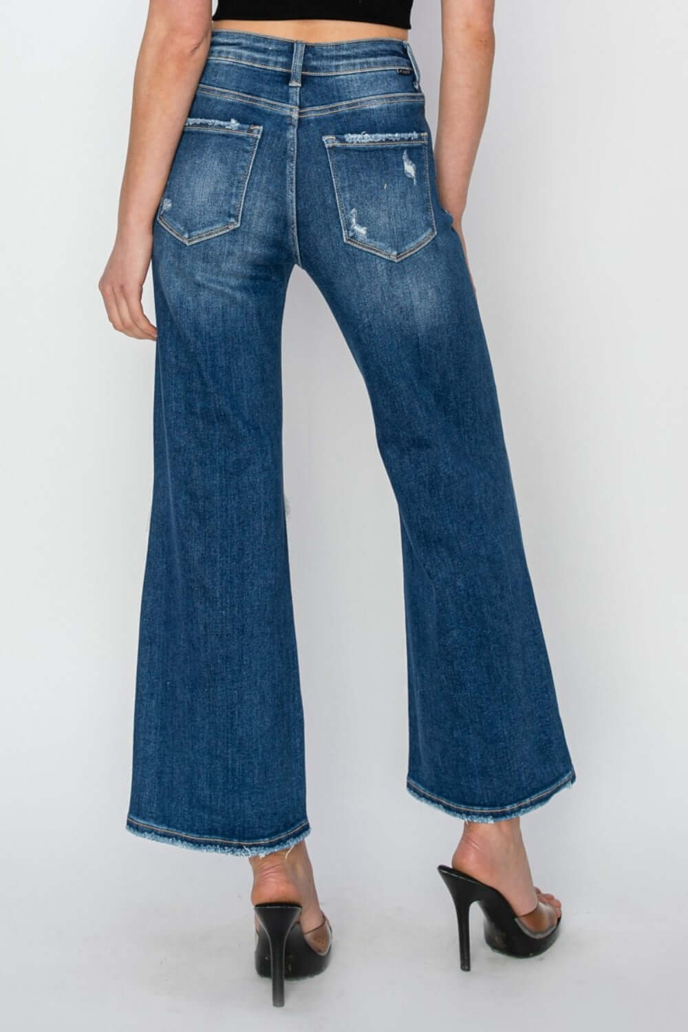 High rise patch detailed wide leg crop jeans, back view showcasing denim design and patch details, perfect for making a fashion statement. Risen Jeans.