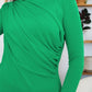 Woman wearing a green ruched mock neck long sleeve t-shirt, perfect for fall layering and cozy style.