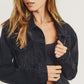 Woman modeling a RISEN distressed long sleeve denim jacket with a vintage look and casual style.