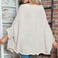 Woman wearing Bella Road Round Neck Batwing Sleeve Sweater with jeans, showcasing its cozy and stylish design.