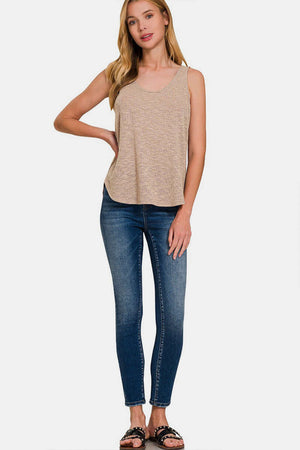 Woman wearing Curved Hem Round Neck Tank paired with blue jeans and black sandals, showcasing a casual and stylish summer look.