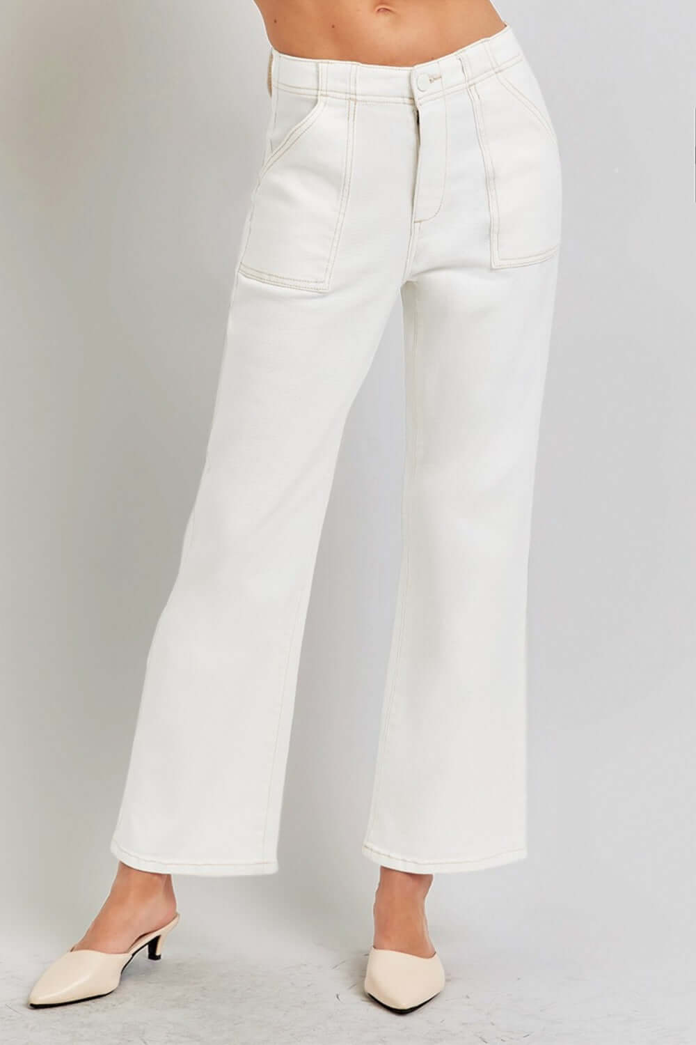 High rise ankle flare jeans with patch pockets in white showcasing retro-inspired silhouette and flattering high-waist fit.