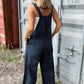 Woman wearing Bella Road plaid wide-leg overalls outdoors, showcasing trendy style with comfortable wide straps and legs.