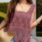 Stylish woman wearing a Bella Road Swim Cutout Cover-Up in mauve with intricate lace details, perfect for beach outings.