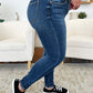 Woman wearing Classic Handsand Skinny Jeans with a hand-sanded finish and black sneakers, showcasing a flattering fit and vintage vibe.