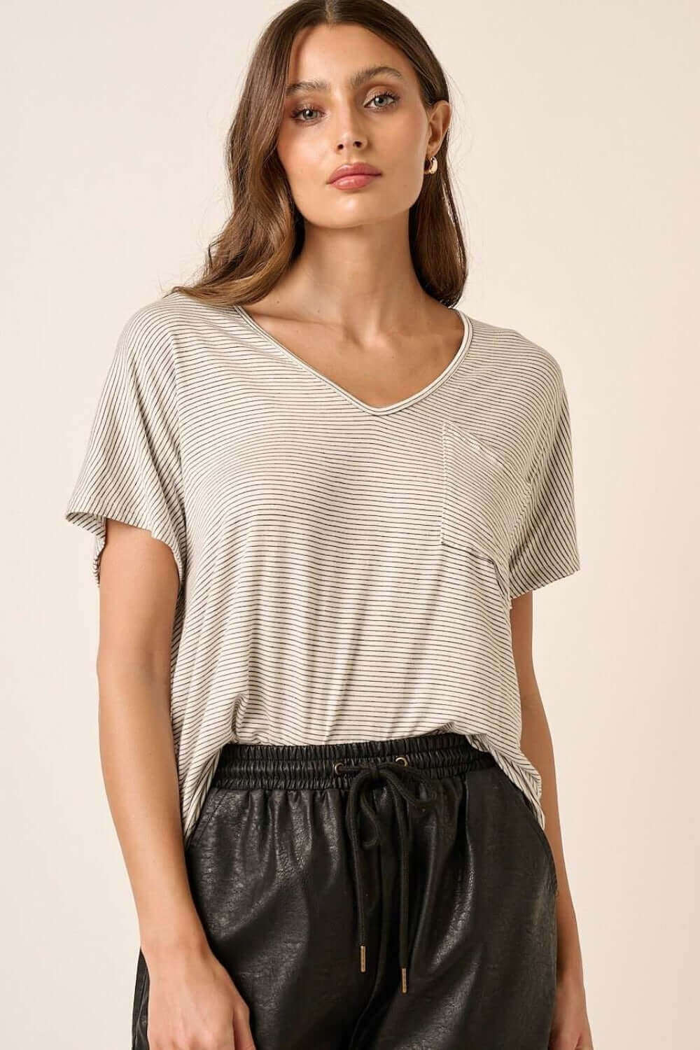 Woman wearing a stylish striped V-neck short sleeve T-shirt, perfect for casual wear. Soft, breathable, high-quality fabric for everyday comfort.