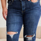 Woman wearing high waist distressed jeans with tummy control and raw hem by RFM Jeans.