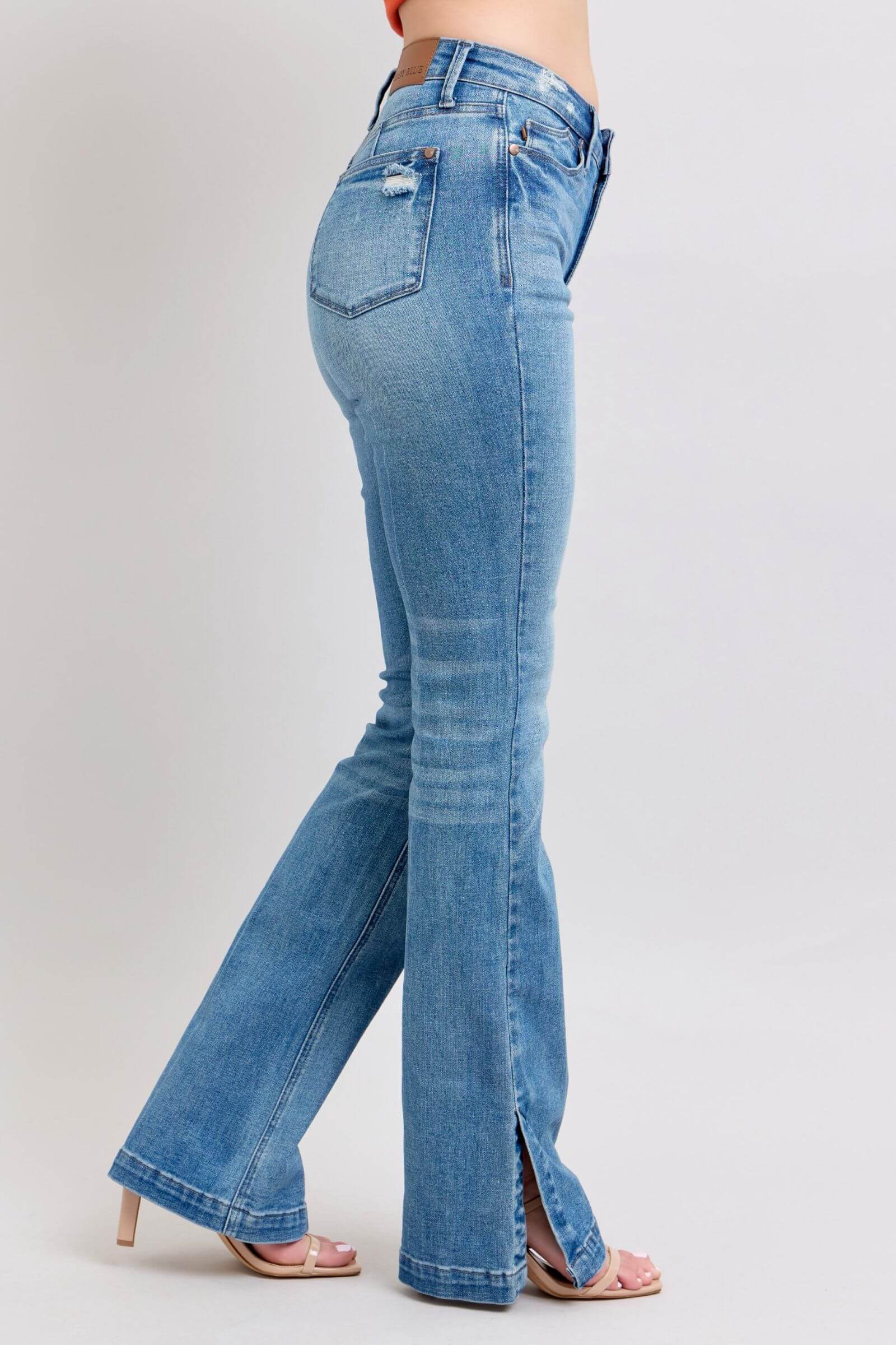 Judy Blue high waist bootcut jeans with side slit in vintage wash, showcasing a flattering fit and stylish silhouette.