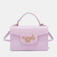 Nicole Lee USA small crossbody wallet in lavender vegan leather with gold logo and adjustable strap.