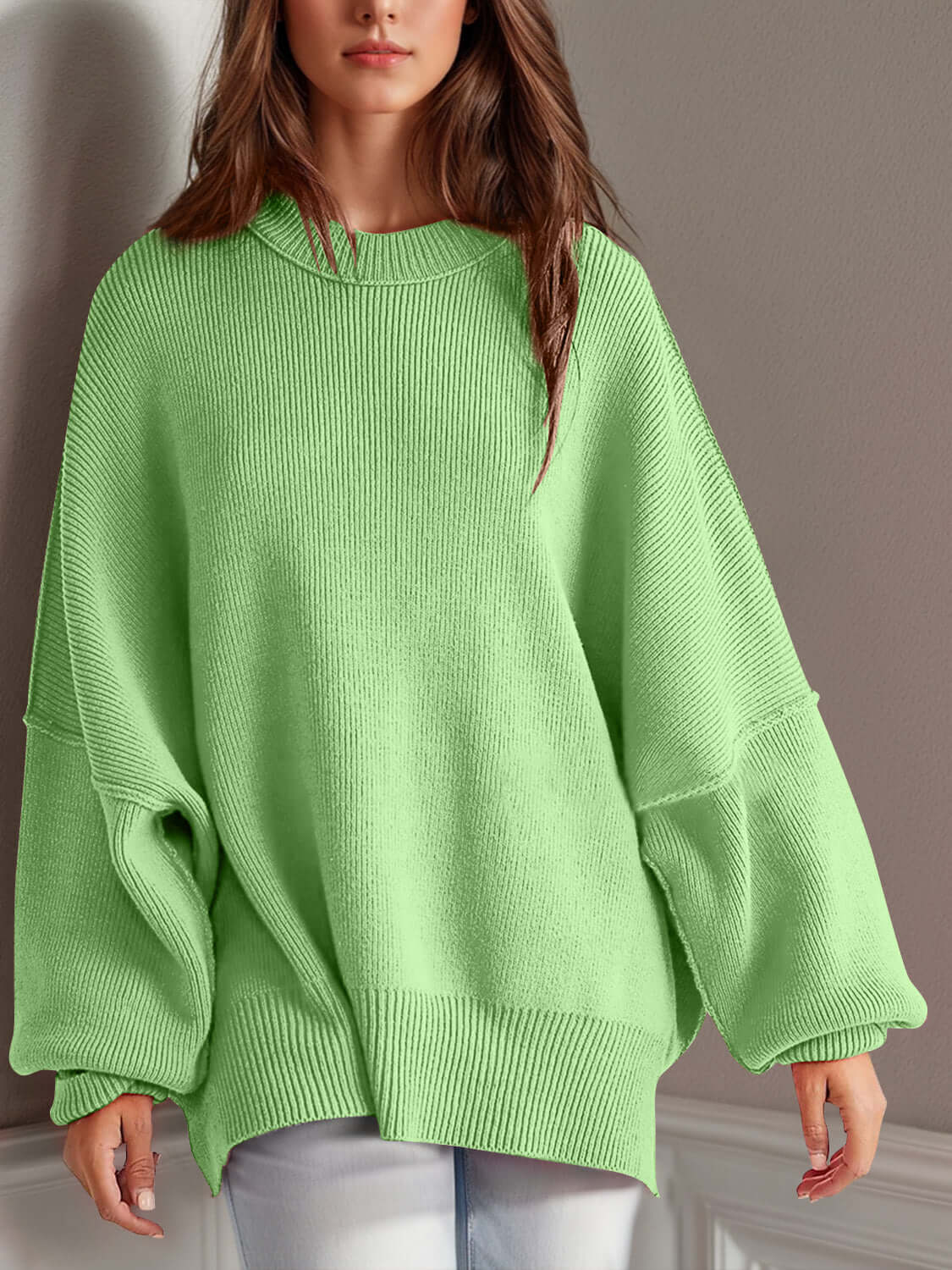 Woman wearing a green Double Take Side Slit Round Neck Long Sleeve Sweater with a playful side slit design.