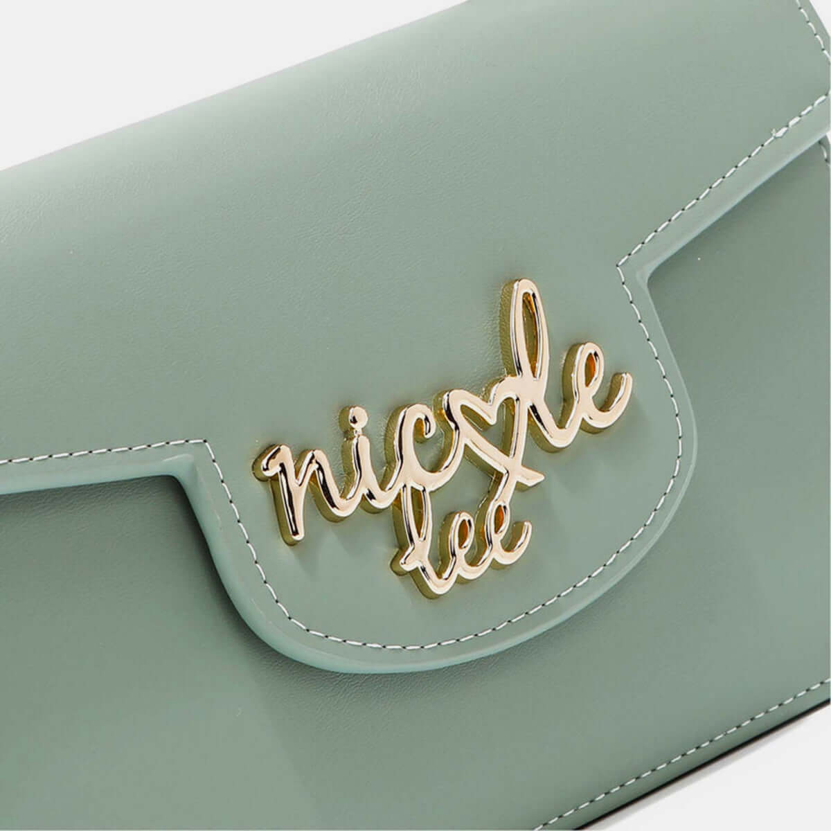 Close-up of Nicole Lee USA small crossbody wallet in vegan leather with gold logo detailing.