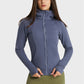 Woman modeling Millennia Zip Up Seam Detail Hooded Sports Jacket in blue, showcasing stylish design and cozy hood for outdoor activities.