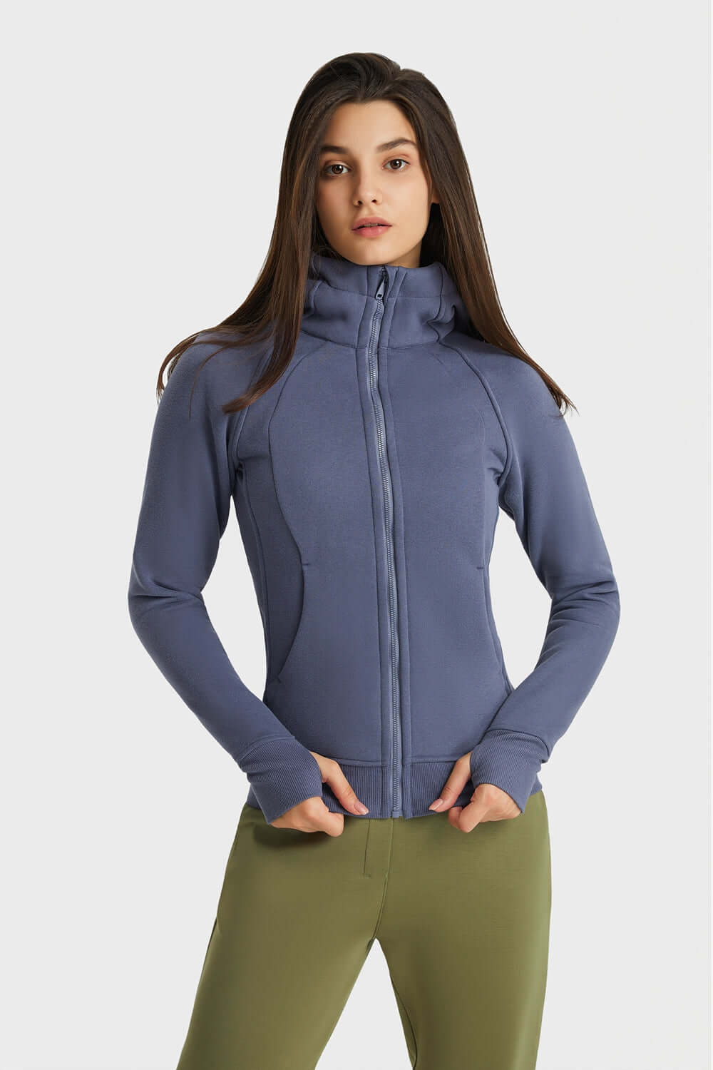 Woman modeling Millennia Zip Up Seam Detail Hooded Sports Jacket in blue, showcasing stylish design and cozy hood for outdoor activities.