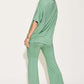 Woman wearing a green Bamboo Drop Shoulder T-Shirt and Flare Pants Set, featuring a basic style with a relaxed fit and stretchy bamboo fiber fabric.