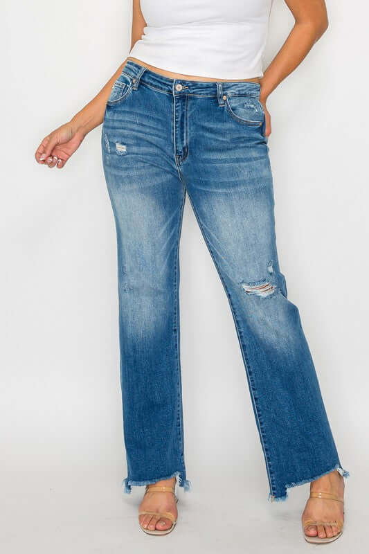 Raw hem distressed mid-rise straight jeans styled with a basic white top and sandals, showcasing trendy casual fashion.