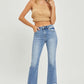 Woman modeling frayed hem cropped straight Risen Jeans with a stylish and casual look, paired with a tan crop top and heels.