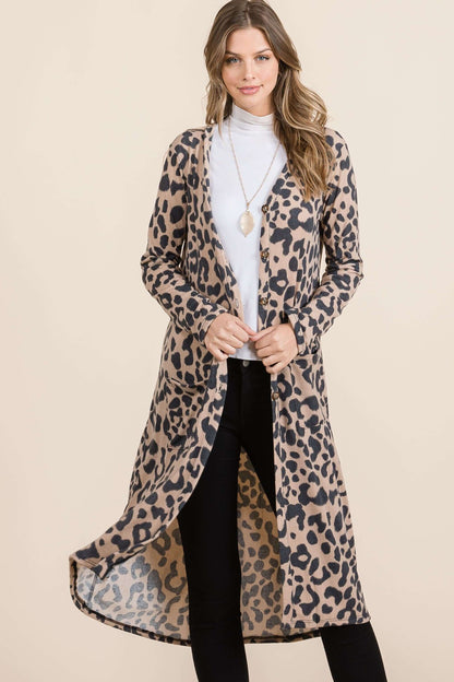 Stylish woman wearing a full size leopard V-neck long sleeve cardigan over a turtleneck, showcasing trendy layering.