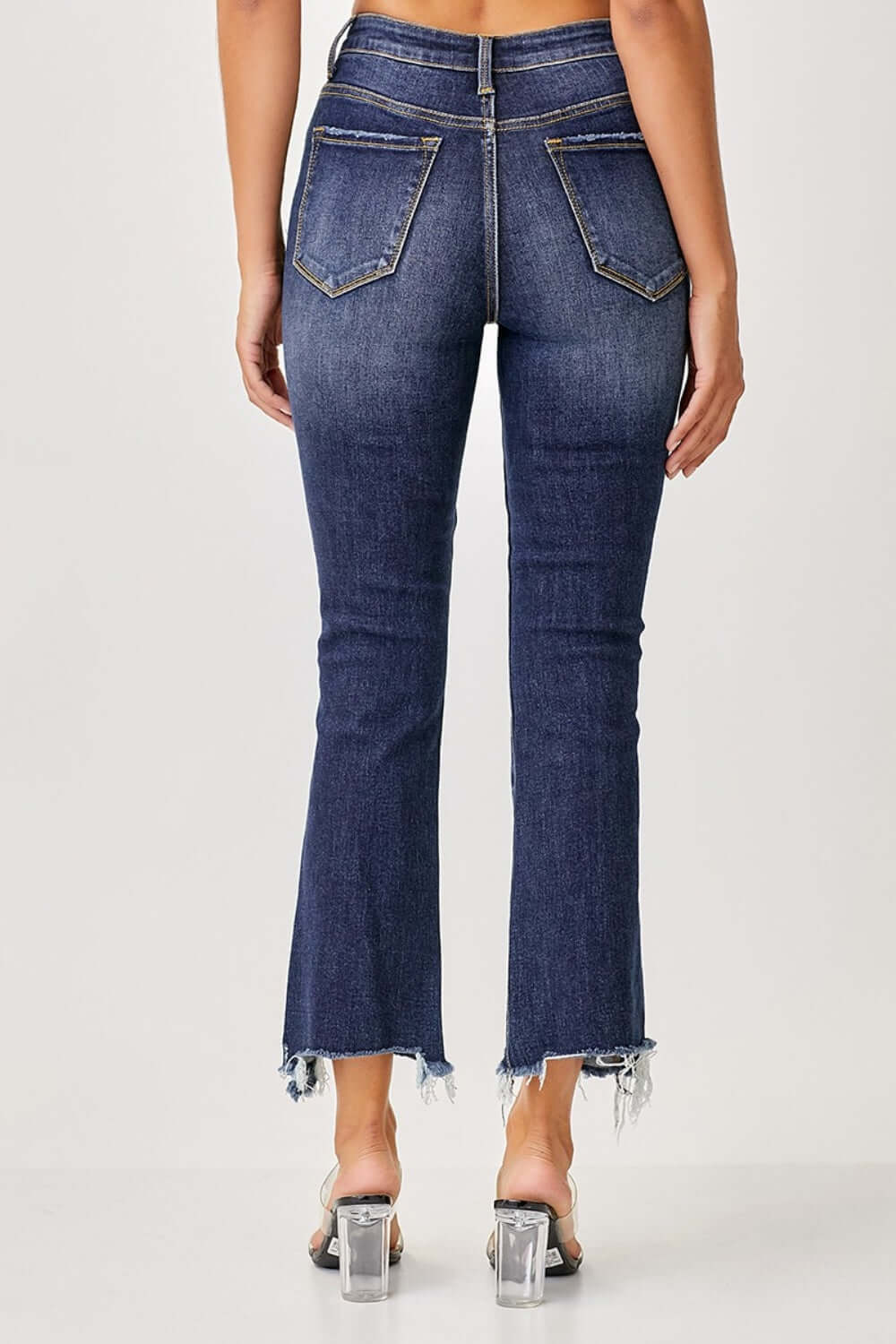 Back view of Risen Jeans frayed hem cropped straight jeans for petite, showcasing trendy style with clear-heeled shoes.