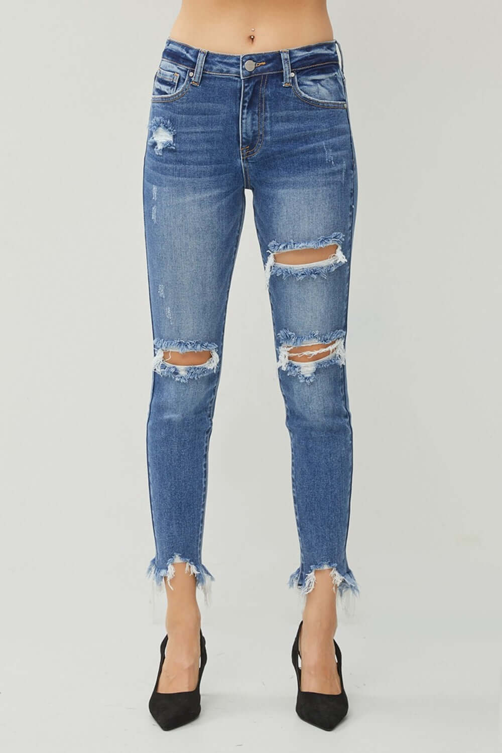 Distressed Frayed Hem Slim Jeans by Risen Jeans with cool rebellious vibe, flattering silhouette, and modern rugged frayed hem design.