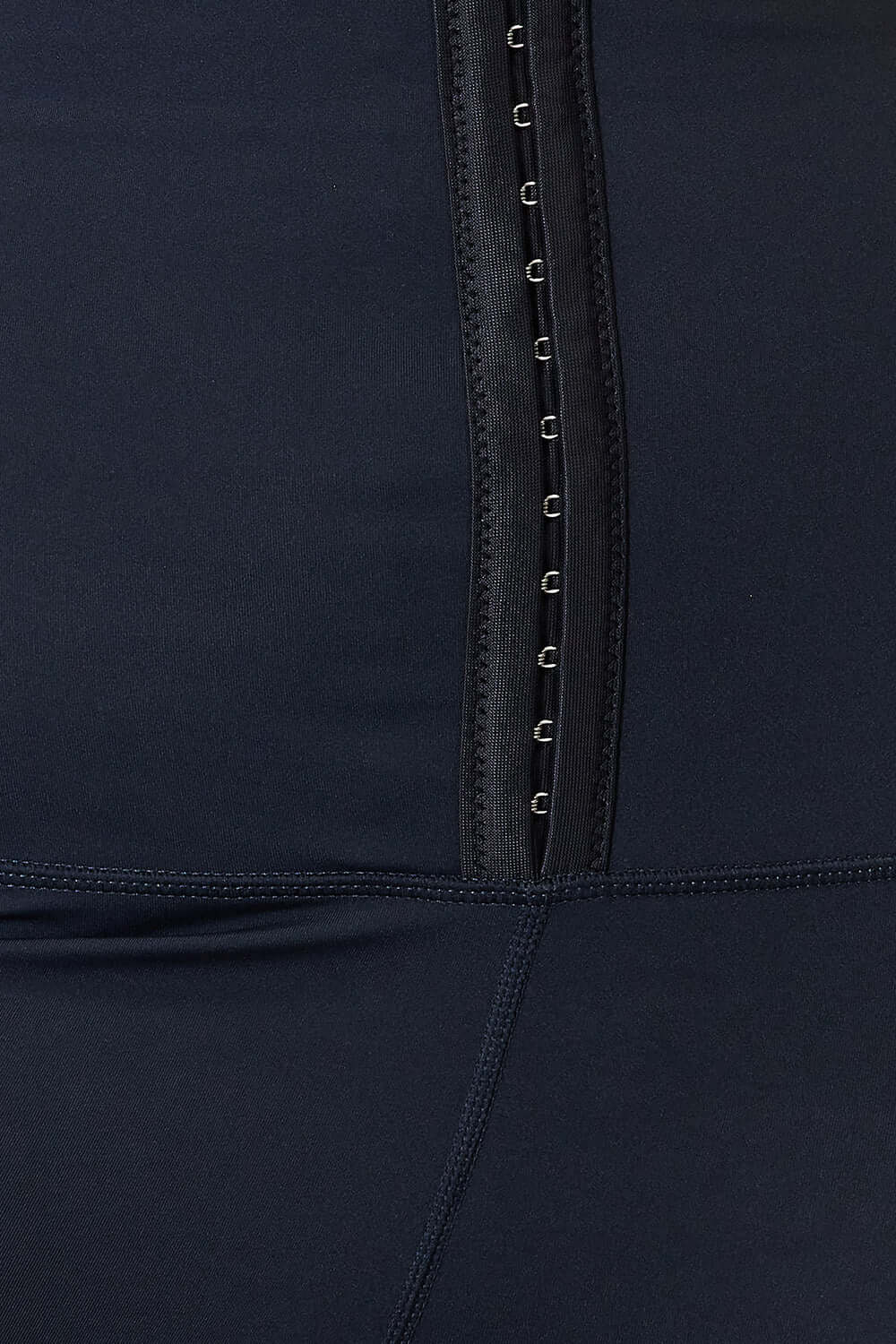 Close-up of Heimish Full Size Waist Trainer Corset Leggings in black showing front hook-and-eye closure detail.