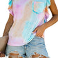 Woman wearing Bella Road Ruffled Printed T-Shirt with round neck and cap sleeves in pastel patterns, paired with denim shorts.