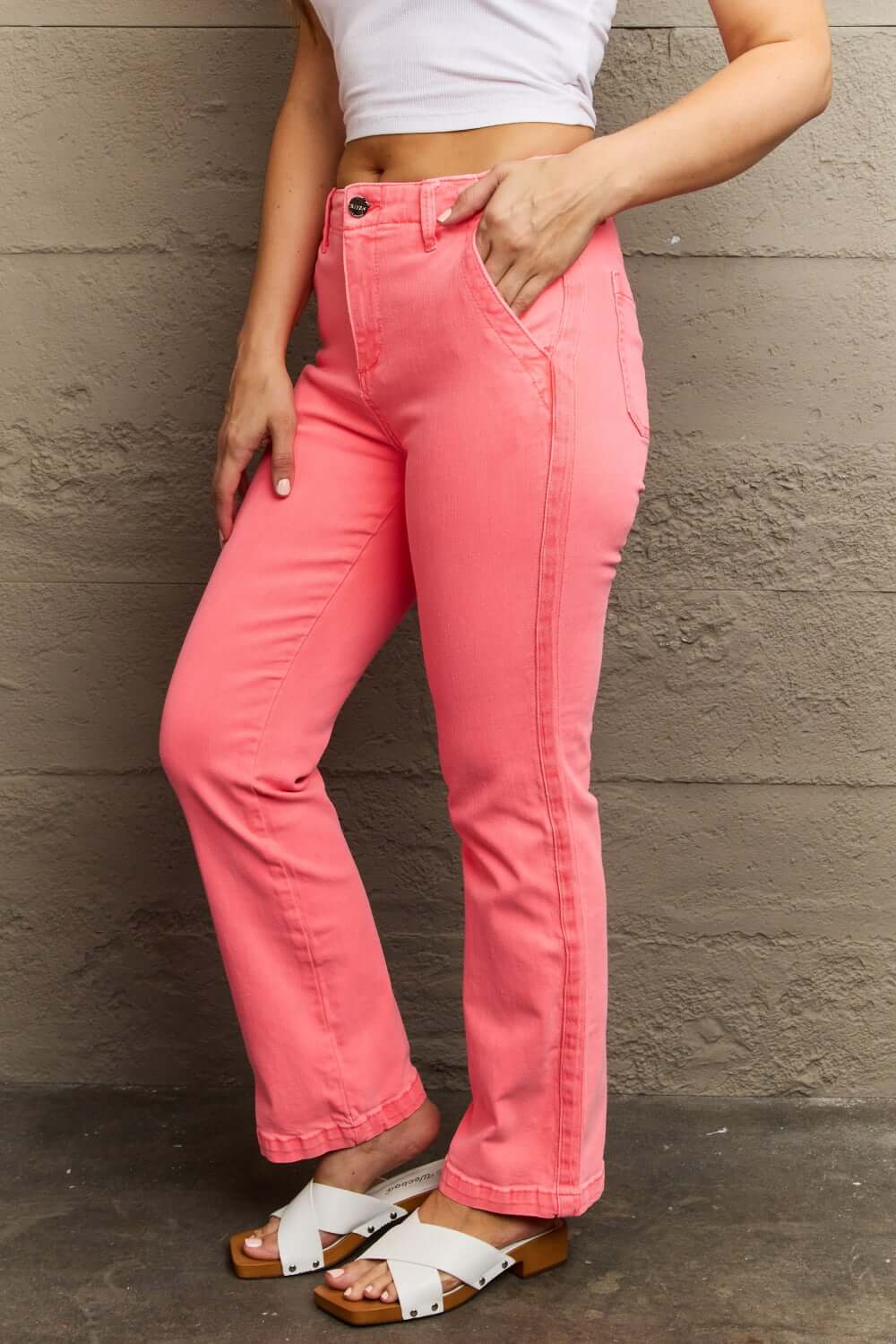 Woman wearing Kenya High Waist Side Twill Straight Jeans in vibrant pink, showcasing elegant Risen Jeans with twill tape detailing