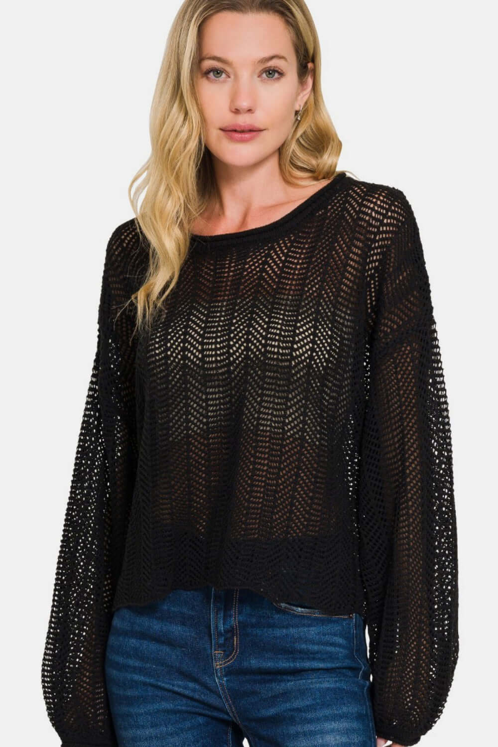 Woman wearing Zenana Hollow Out Long Sleeve Knit Cover Up in black, showcasing trendy eyelet detailing and stylish layers.