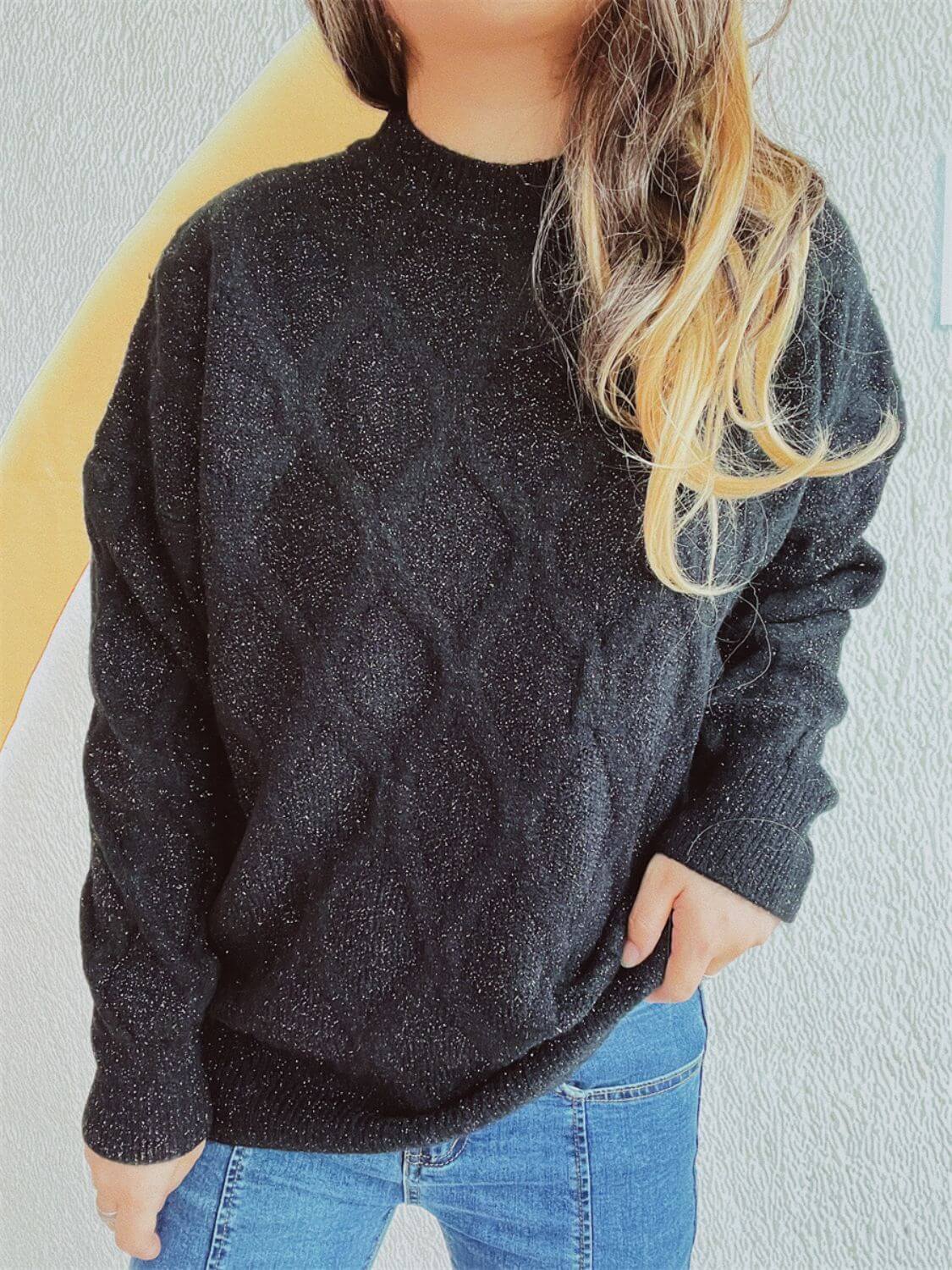 Bella Road diamond pattern round neck long sleeve sweater in black worn with blue jeans