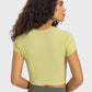 Model showcasing the Millennia cropped sports t-shirt in soft green, perfect for yoga and stylish workouts.