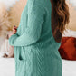 Woman wearing a textured open front cover up with pockets in teal, featuring a slightly stretchy, opaque fabric made of 97% polyester and 3% elastane.