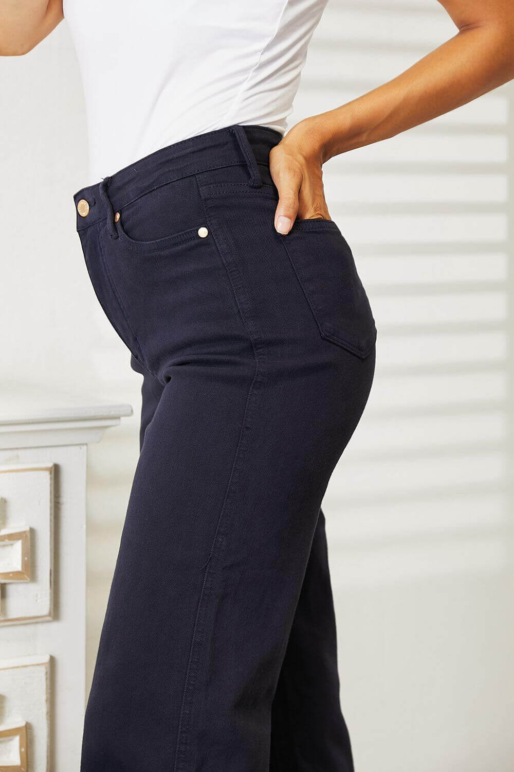 Woman wearing high waist tummy control Judy Blue wide cropped jeans in garment-dyed finish