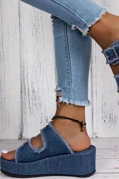 Model wearing Bella Road Raw Hem Wedge Buckle Sandals in denim paired with distressed jeans.