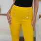 Bright yellow FAM-FAM high waist skinny pants with decorative buttons, perfect for elevating your outfit with style.