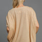 Back view of Umgee Exposed Seam Round Neck Batwing Sleeve Knit Top in soft beige, showcasing cozy appeal and stylish design.