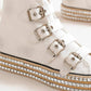 Edgy white platform sneakers with multi-buckle straps and studded detailing for a trendy, rock 'n' roll vibe.